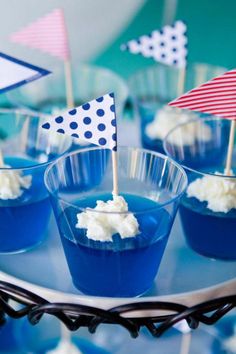 small cupcakes in blue cups with flags on them