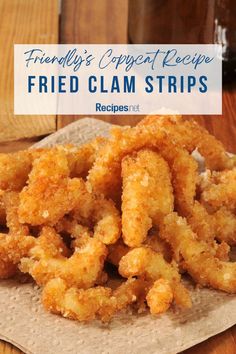 fried clam strips sitting on top of a piece of paper