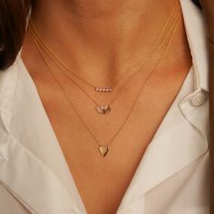 This petite diamond bar necklace is the perfect everyday staple. Simple and classic on its own, it is also a great layering necklace. This dainty 14 karat gold and diamond bar necklace features white round diamonds bezel set in a row. The bezel settings wrap around each diamond providing not only a modern look but also a protective setting. This piece is a contemporary twist on the classic diamond bar necklace. The adjustable chain means this beauty will look perfect with any neckline and makes Everyday White Gold Diamond Necklace, Everyday Gold Bar Necklace With Diamond, Everyday Diamond Birthstone Necklace, Minimalist Diamond Necklace With Baguette Diamonds, Everyday Yellow Gold Diamond Bar Necklace, Dainty Yellow Gold Diamond Bar Necklace, Minimalist Baguette Diamond Necklace, Dainty Everyday Diamond Necklace With Bezel Setting, Everyday Dainty Necklace With Single Cut Diamonds