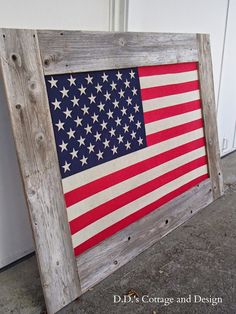 an american flag is displayed in a wooden frame