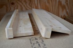 two pieces of wood sitting on top of a table