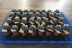 there are some cupcakes with blue frosting and googly eyes on them