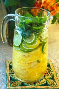 a pitcher filled with lemonade and lime slices