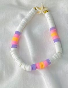 a white necklace with multicolored beads