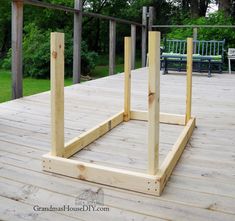 a wooden deck with benches in the background