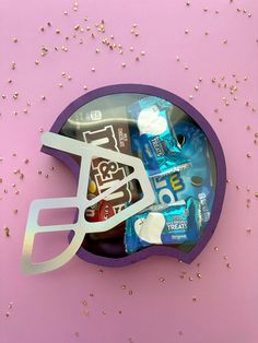 a football helmet shaped box filled with toothpaste, mouthwashes and water