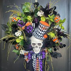 a wreath decorated with halloween decorations and skulls