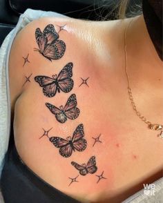 a woman's back with butterflies on it