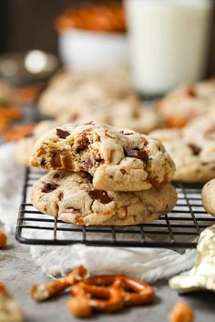 cookies and pretzels on a cooling rack with glass of milk in the background