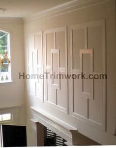 an empty room with white painted walls and wood trimmings on the fireplace mantel