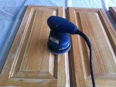 an electric sander sitting on top of a wooden door