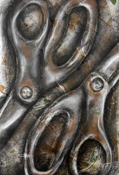 a close up of a pair of scissors on a piece of metal with green leaves growing out of it