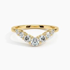 a yellow gold ring with three diamonds on it