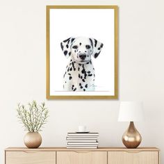 a white and black dalmatian puppy dog with spots on it's face