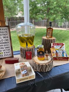 a table topped with different types of food and drinks on top of a blue table cloth