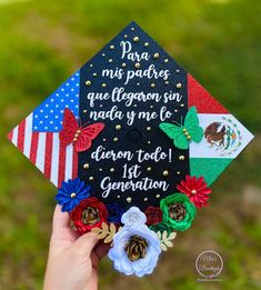 someone is holding up a graduation cap decorated with flowers and the mexican american flag on it