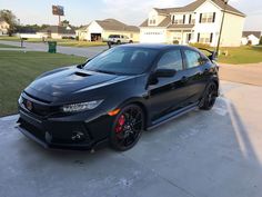 a black car parked in front of a house