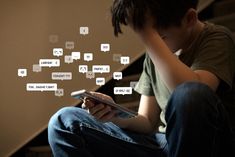 a young boy sitting on the stairs looking at his cell phone with speech bubbles coming out of it