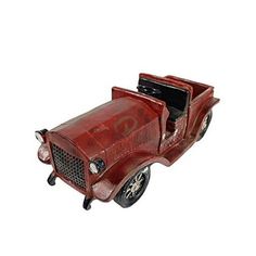 an old red model car on a white background