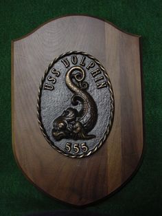 a wooden plaque with a snake on it