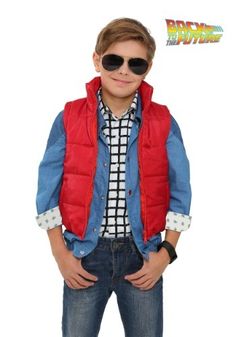 a young boy wearing sunglasses and a red vest is standing with his hands in his pockets