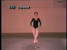 a woman in black leotard and ballet shoes is standing on the dance floor