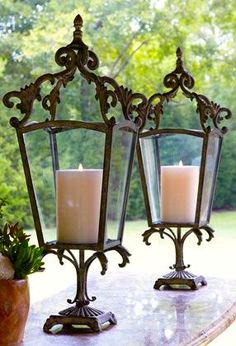 two candles are sitting on top of a table