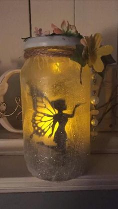 a glass jar with a fairy on it