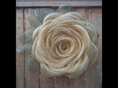 a close up of a flower on a wooden fence