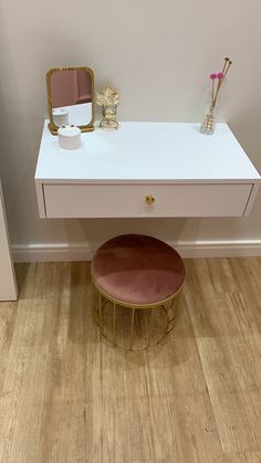 a white desk with a mirror and stool