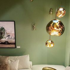 a living room filled with white furniture and lots of lights hanging from it's ceiling