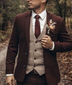 a man wearing a suit and tie in the woods