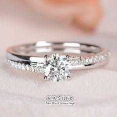 a diamond engagement ring on top of a white blanket