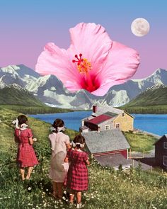 three girls looking at a pink flower in front of a lake and mountains with the moon