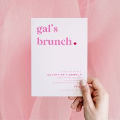 a person holding up a card with the words gal's brunch on it