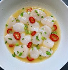 a white bowl filled with food on top of a table