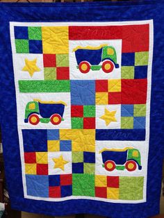 a blue quilt with trucks and stars on it