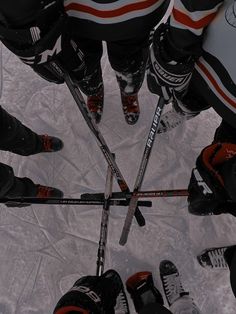 a group of people standing in the middle of a circle with their skis on