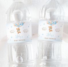 two baby shower bottles with teddy bears on them