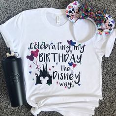 a white shirt with the words celebrating my birthday is the disney way on it next to a black cup