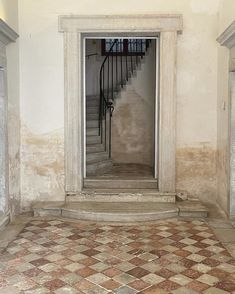 an empty room with stairs and tiled floor