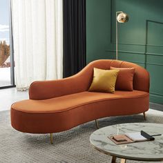 a living room with green walls and a couch in the middle, next to a coffee table