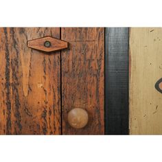 an old wooden door with a metal knob on the front and side panel, next to another wood door