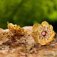 "Embrace the enchanting allure of poppy flowers with our sterling silver and gold stud earrings, each adorned with a vibrant gemstone center in your choice of blue topaz, garnet, peridot, or amethyst. 🌺💎 Crafted with meticulous detail, these earrings capture the delicate beauty of poppies in bloom, symbolizing beauty, remembrance, and vitality. Add a touch of elegance and personal flair to your ensemble with these exquisite studs, perfect for expressing your unique style and personality." 🌿✨ 14k Gold Flower-shaped Earrings, 14k Gold Flower-shaped Matching Earrings, Yellow Gold Flower Jewelry With Matching Earrings, 14k Gold Flower Earrings Jewelry, 14k Gold Flower Earrings With Matching Set, Flower Shaped Pierced Jewelry For Anniversary, 14k Gold Flower Shaped Gemstone Jewelry, Hallmarked Sterling Silver Flower Earrings Gift, 14k Gold Flower Earrings For Gift