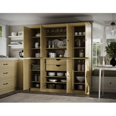 an open cabinet in a kitchen filled with dishes