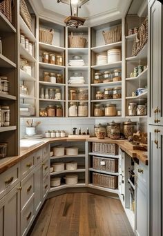 a kitchen filled with lots of wooden shelves