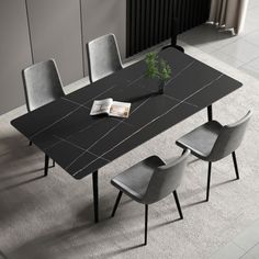 a black table with four chairs and a book on it in front of a radiator