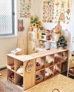 a child's playroom with toys and decorations on the wall, including shelves