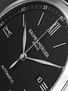 The watches in Baume & Mercier's 'Classima' range are defined by a slim profile that comfortably sits under shirt cuffs. This polished stainless steel reference has an easy-to-read dial with rhodium-plated hands, Roman numerals and indices, and is equipped with a Swiss-made automatic Sellita SW200 movement. The smooth black leather strap matches the clean display. We offer a two-year warranty for all working parts and manufacturing faults for luxury watches. For more information, contact one of… Under Shirt, Baume Mercier, Dress Watch, Polished Stainless Steel, Roman Numerals, Swiss Made, Black Watch, Luxury Watches, Rhodium Plated