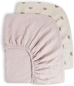 three baby swaddles in various colors and patterns, one is pink and the other is white